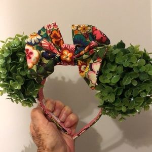 Specialty garden headband decorated with leaves and cotton floral pattern bow.